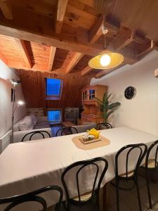 a dining room with a white table and chairs at Le Domaine Belinay in Paulhac