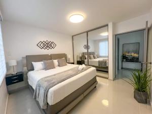 a bedroom with a large bed and a large mirror at Isabela Luxury Escape in Isabela