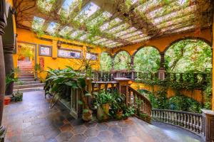an indoor garden with plants in a building at La Hacienda Hotel, at Xcaret in Playa del Carmen +17 photos