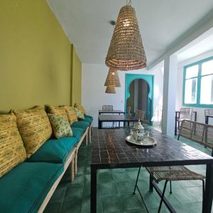 a living room with a couch and a table at Dar Raphael in Essaouira