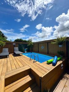 a wooden deck with a swimming pool and a wooden deck at Villa Morivivi Couples with pool in Tierras Nuevas Poniente