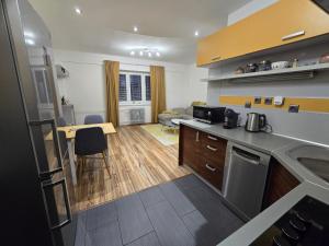 a kitchen and living room with a counter top at Central City Stay Šancová in Staré Mesto