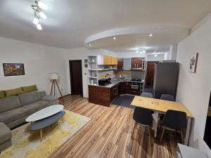a living room with a couch and a table at Central City Stay Šancová in Staré Mesto