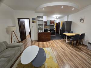 a living room with a couch and a table at Central City Stay Šancová in Staré Mesto