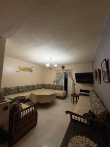 a living room with a couch and a table at Palm Beach in Mansouria