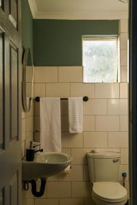 a bathroom with a toilet and a sink at Luxe Residence Guest House in Kasane +38 photos