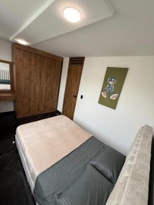 a bedroom with a bed and a wall at Casa ibague in Ibagué +3 photos