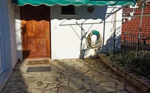 a door to a house with a cobblestone walkway at Super central apartment with a view in Karpenisi