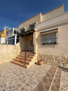 a building with a stone walkway in front of it at Rekkehus med uteplass in La Florida