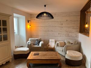 a living room with two chairs and a coffee table at La cachette chic ! in Sainte-Hélène-du-Lac