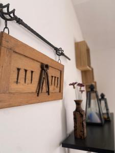 a wooden frame hanging on a wall with a vase at Colonia Natura Apartmanpark in Sitke +34 photos