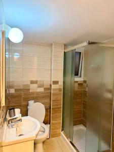 a bathroom with a toilet and a sink and a shower at Relax Beach Apartment in Larnaca +82 photos