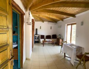 a hallway with a living room with wooden ceilings at Colonia Natura Apartmanpark in Sitke