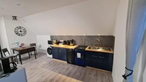 a kitchen with a sink and a table in a room at Ferienwohnung Richter in Pirna