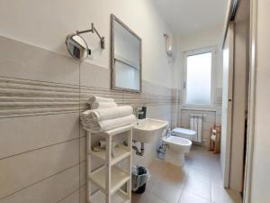 a white bathroom with a sink and a toilet at My Way Rooms - Affittacamere in centro Trieste in Trieste