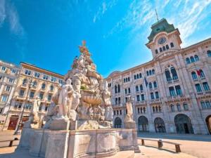 a fountain in front of a large building at My Way Rooms - Affittacamere in centro Trieste in Trieste +28 photos