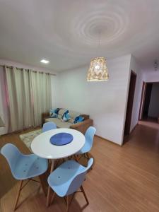 a living room with a table and chairs and a couch at Torres dos Holandeses Vista Mar in São Luís