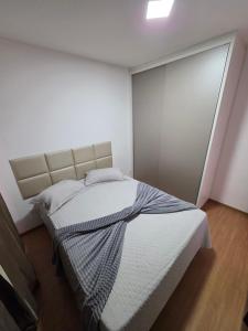 a bedroom with a bed in a white room at Torres dos Holandeses Vista Mar in São Luís +13 photos