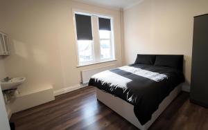 a bedroom with a bed and a sink in it at Atherley House - Winter Sale! Spacious Self Catered Rooms in Southampton