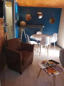 a living room with a couch and a table at Le cocon du sancy in Besse-et-Saint-Anastaise