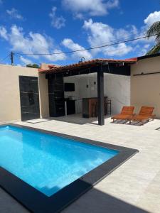 a swimming pool in front of a house at Casa veraneio2 in Camacari