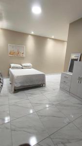 a room with a bed and a dresser in it at Casa veraneio2 in Camacari
