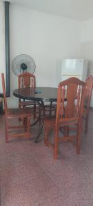 a glass table with two chairs and a table with at La casa de Los Patitos in Arroyo de Los Patos +15 photos