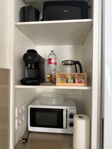 a kitchen with a microwave on a shelf at Ca La Rosalia Arbeca in Arbeca