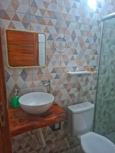 a bathroom with a sink and a toilet and a mirror at Costamar Galinhos in Galinhos +32 photos