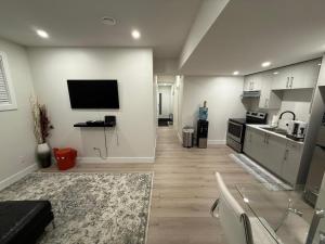 a living room with a television and a kitchen at 2 Bedrooms Private EntRance wifi Free Parking in Prince George +1 photo