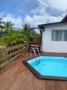 a swimming pool on a deck with a house at Withsun in Saint-Louis
