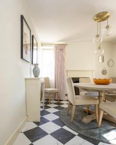 a dining room with a table and chairs at Luxurious Town Centre Apartments in Cirencester +57 photos