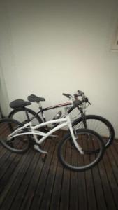 a bike is parked on a wooden floor at Conchas Lofty in Governador Celso Ramos
