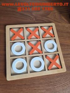 a puzzle game with red crosses in a wooden box at Le volte di Umberto Tramontana in Sogliano Cavour