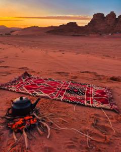 a pot sitting on top of a net on the desert at wadi rum luxe tours in Wadi Rum