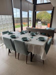 a dining room table with glasses and plates on it at Casa de Muranzel in Torreira