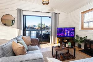 a living room with a couch and a tv at Swanmere lodge, Lakeside view Pinelake Carnforth in Carnforth