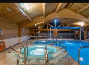 a large indoor swimming pool in a building at Swanmere lodge, Lakeside view Pinelake Carnforth in Carnforth