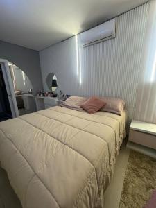 a bedroom with a large bed in a room at Excelente casa com piscina próx ao Mar in Capão da Canoa