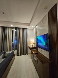 a living room with a large flat screen tv at Elevenstay in Ghaziabad