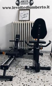 a gym with two exercise bikes and a chair at Le volte di Umberto Scirocco in Sogliano Cavour +28 photos