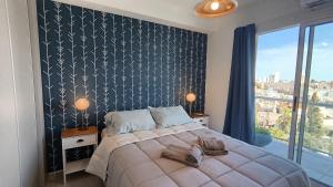 a bedroom with a large bed with a black and white wall at Apart Alameda in Paraná