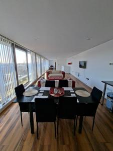 a dining room with a table and chairs and a couch at Elegant three bedroom flat in Darlington