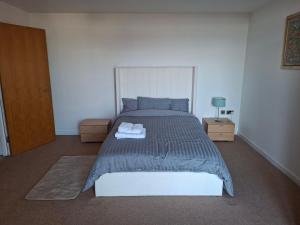 a bedroom with a large bed with two night stands at Elegant three bedroom flat in Darlington