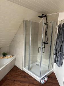 a shower with a glass door in a bathroom at Michaels Elbtraum in Drochtersen +24 photos