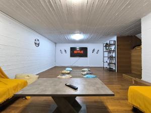 a room with a table and a tv in it at Psalidi beach loft house in Psalidi