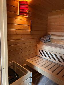 a wooden sauna with a bed and a red light at Michaels Elbtraum in Drochtersen