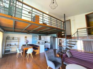 a living room with a loft with a staircase at Psalidi beach loft house in Psalidi