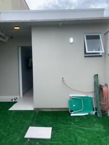 a television sitting on the grass next to a building at Conchas Lofty in Governador Celso Ramos