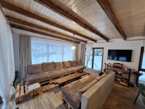 a living room with a couch and a large window at Casa Delia in Balta